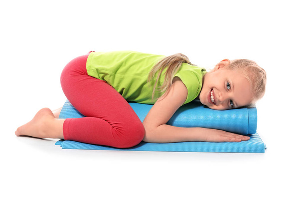Little girl with yoga mat on white background - Foto, immagini