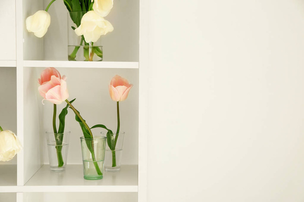 Vases with beautiful tulips on shelves - Foto, Imagen