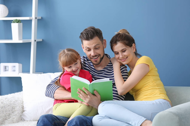Happy family reading book together at home - Photo, Image