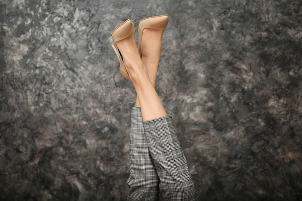 Legs of beautiful young woman on dark grey background - Fotoğraf, Görsel