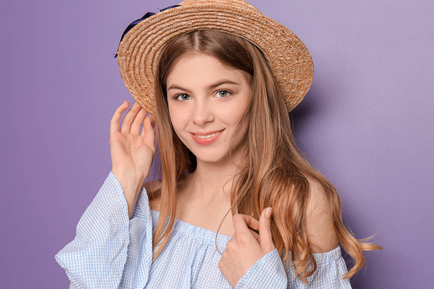Beautiful young woman with hat on color background - Photo, Image