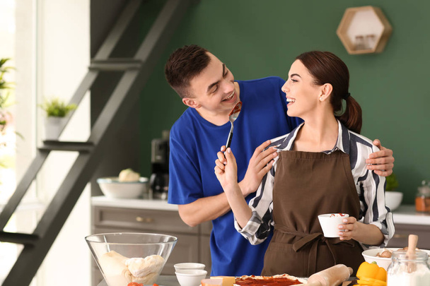 Young couple cooking together in kitchen - Foto, immagini