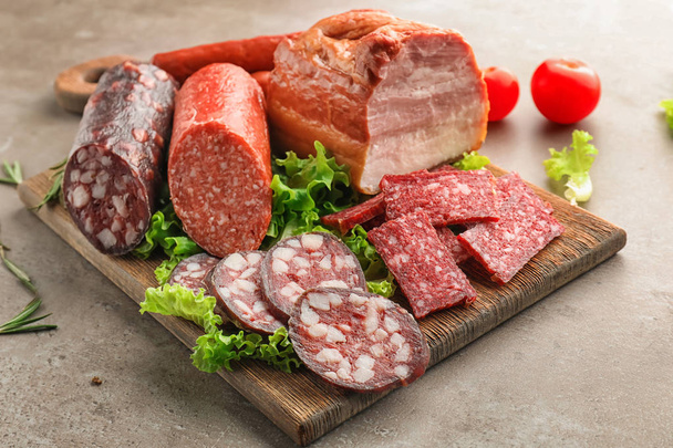 Assortment of delicious deli meats on wooden board - Photo, Image