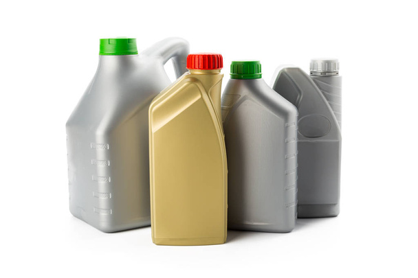 Plastic bottles from automobile oils isolated on white background, close-up  - Valokuva, kuva