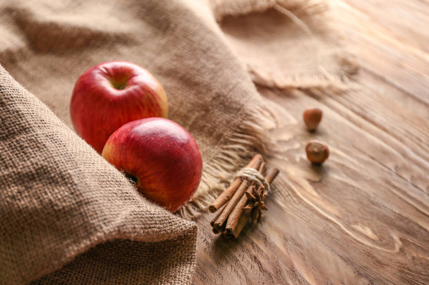 Fresh apples and cinnamon on wooden table - Фото, изображение