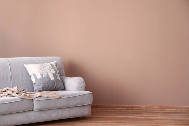 Comfortable sofa near color wall in living room - Φωτογραφία, εικόνα