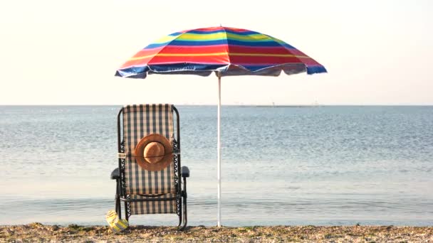 Chaise lounge deck chair and umbrella. - Footage, Video