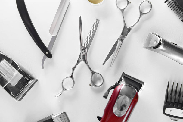 Men's Grooming Tools. Barber Equipment And Supplies On White Table. Closeup Of Scissors And Shaving Trimmer And Blades. High Resolution - 写真・画像
