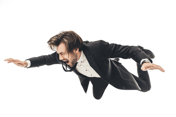 screaming young businessman in suit falling isolated on white - Фото, изображение