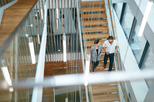 Business People Working In Modern Office. Man And Woman Walking On Stairs In Contemporary Business Center Interior. High Resolution - Fotografie, Obrázek
