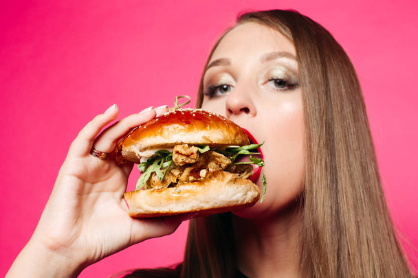 Hungry girl biting burger. - Valokuva, kuva