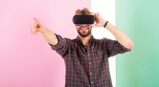 Cyber space. Man unshaven guy with VR glasses involved in cyber space, pink background. Hipster use modern technologies for entertainment. Guy VR glasses head mounted display interact in cyber space - Photo, Image