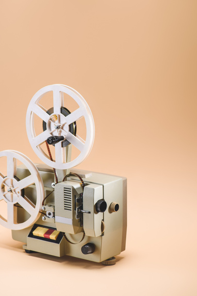 close up view of old film projector on beige background - Photo, Image