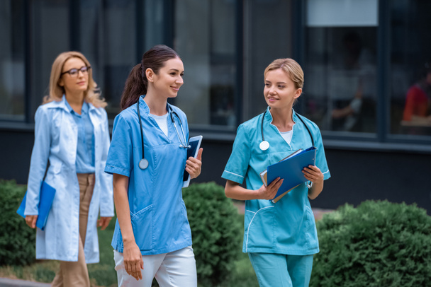 medical students and lecturer walking on street near university - Photo, Image