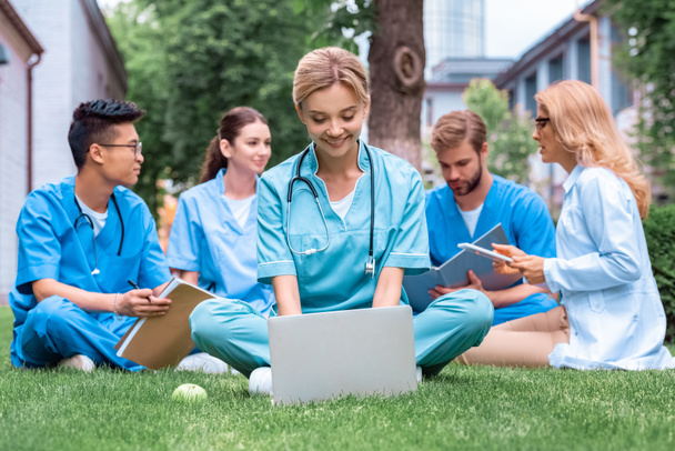 Lehrer und multiethnische Studenten, die an der medizinischen Universität mit Geräten im Freien studieren - Foto, Bild
