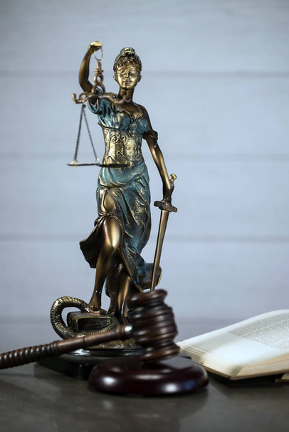 Адвокатская контора с весами правосудия, молотком и старыми юридическими книгами на заднем плане
 - Фото, изображение