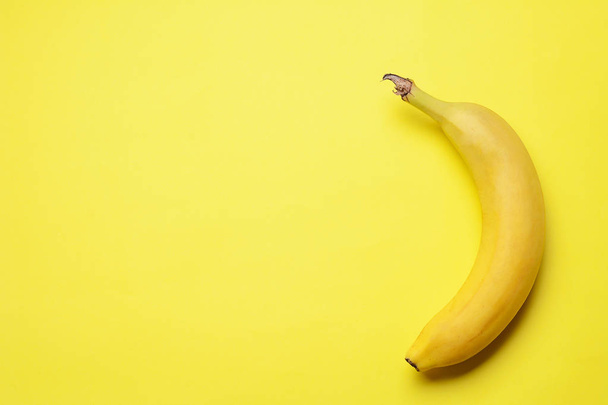 Top view. Bunch of bananas on yellow background. Healty concept - Foto, Imagen