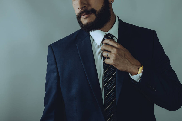 Beard man in a blue suit smirks  - Zdjęcie, obraz