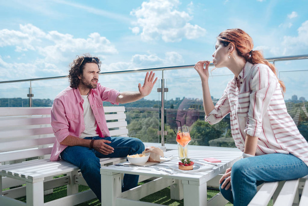 Curly man not liking manners of his girlfriend - Photo, image