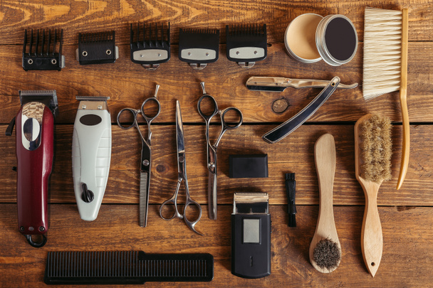 top view of professional hairdressing equipment on wooden table in barbershop - Photo, Image