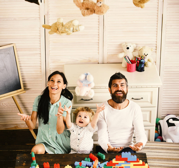 Parents and son with happy faces play with soft toys - Foto, Imagem