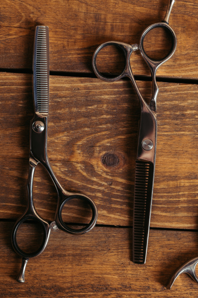 top view of professional scissors on wooden surface in barbershop  - Photo, Image