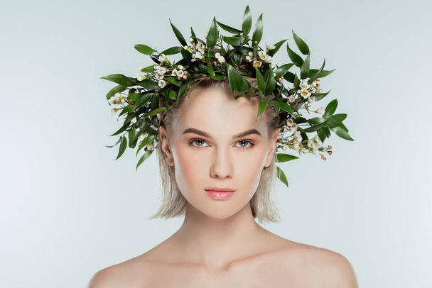 naked blonde girl in floral wreath, isolated on grey - Photo, Image