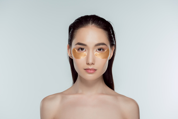 beautiful asian girl with golden eye patches, isolated on grey - Φωτογραφία, εικόνα