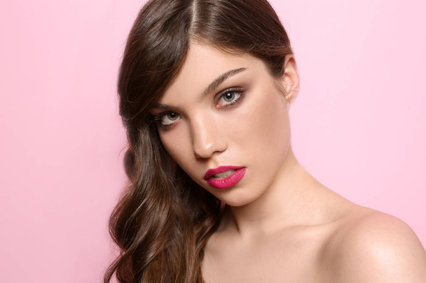 Portrait of young woman with professional makeup on color background - Fotoğraf, Görsel