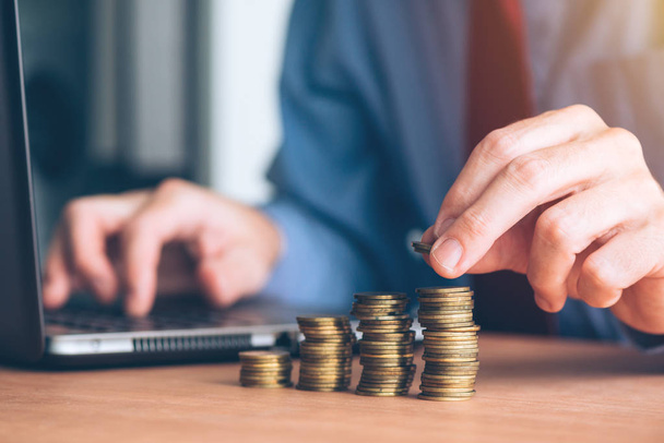 Finances and budgeting, businessman stacking coins on office desk - Fotografie, Obrázek