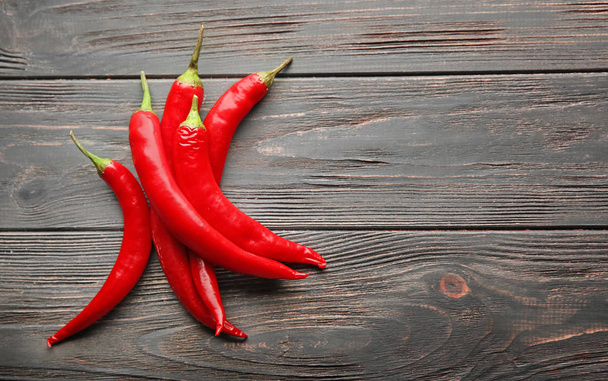 Fresh chili peppers on wooden background - Photo, Image