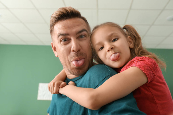 Funny portrait of father and daughter at home - Photo, Image