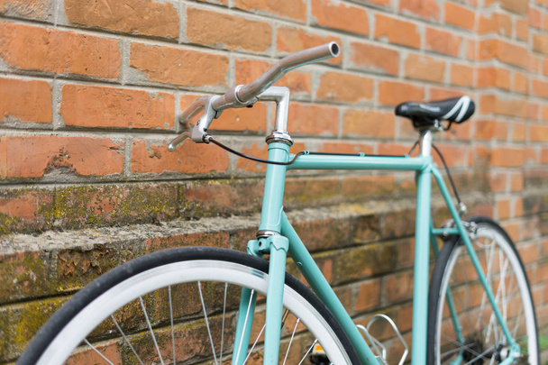 detail of bicycle, near brick wall - Foto, imagen