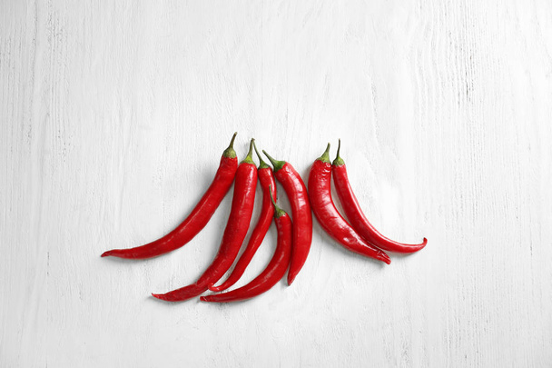 Fresh chili peppers on white wooden background - Photo, Image