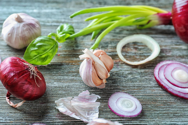 Fresh garlic and onion on wooden background - Фото, зображення