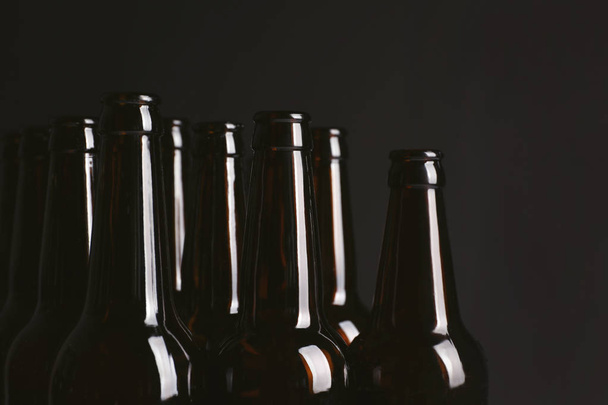 Botellas de vidrio de cerveza fría sobre fondo oscuro, primer plano
 - Foto, Imagen