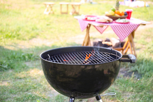 Modern barbecue grill with flame outdoors - Fotó, kép