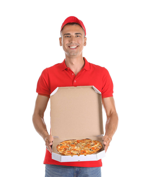 Young man holding box with tasty pizza on white background. Food delivery service - Foto, Imagem