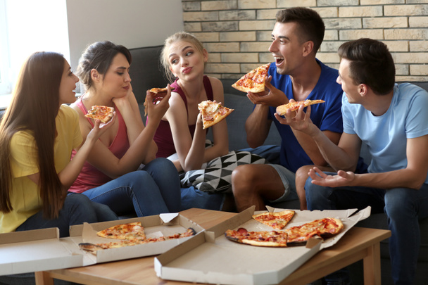 Young people having fun at party with delicious pizza indoors - Photo, Image