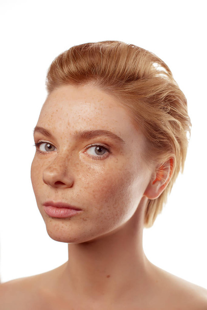 Young beautiful freckles woman face portrait with healthy skin - Фото, зображення