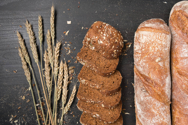 fresh bread and wheat on the wooden - Fotoğraf, Görsel