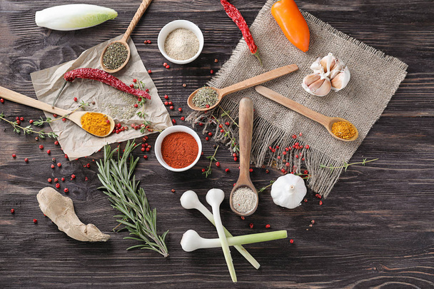 Various spices with herbs on wooden background - 写真・画像