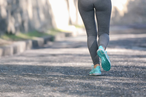Sporty young woman running outdoors - Foto, Bild