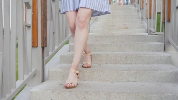 Perfect female legs in shoes stepping down on stairway. - Footage, Video