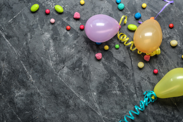 Birthday party balloons with candies on grey background - Photo, Image