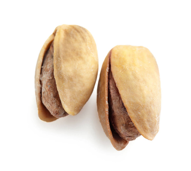 Tasty pistachio nuts on white background - Foto, Imagen
