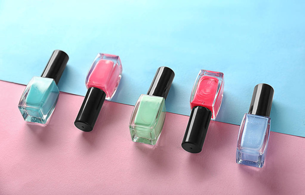 Bottles of nail polishes on color background - Photo, Image