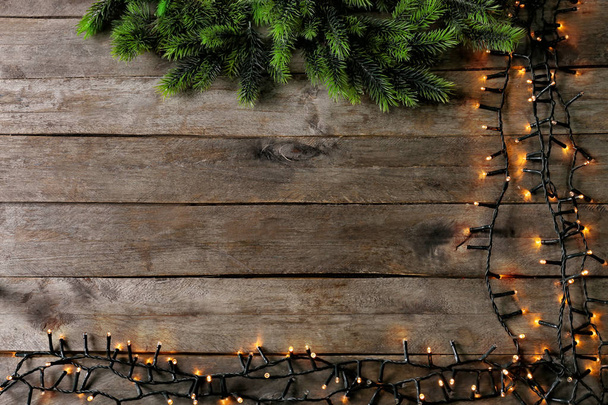 Christmas garland with fir tree branches on wooden background - Photo, Image