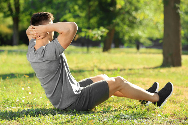 Sporty man training in park - Photo, Image