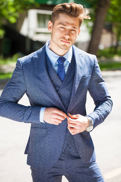Portrait of a cheerful businessman in blue suit, summer street outdoors - Фото, зображення